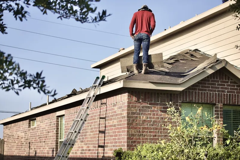 Professional roofer working on a residential roof in On Top of the World